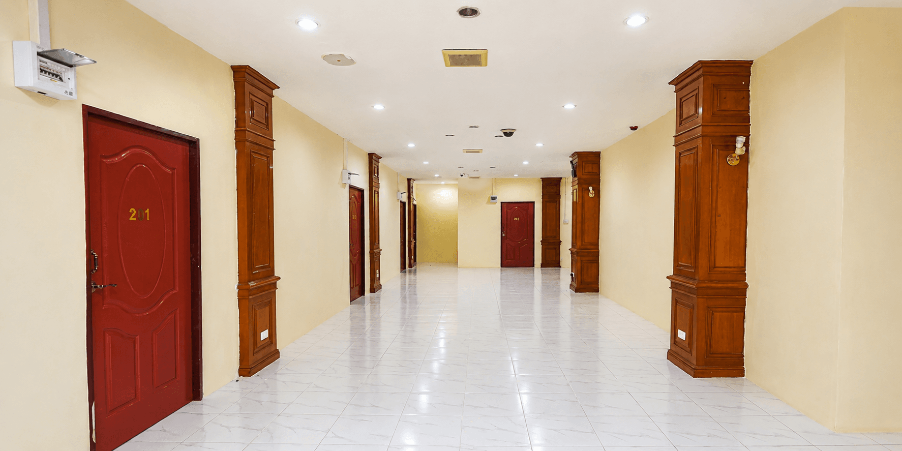 Spacious hotel corridor leading to guest rooms