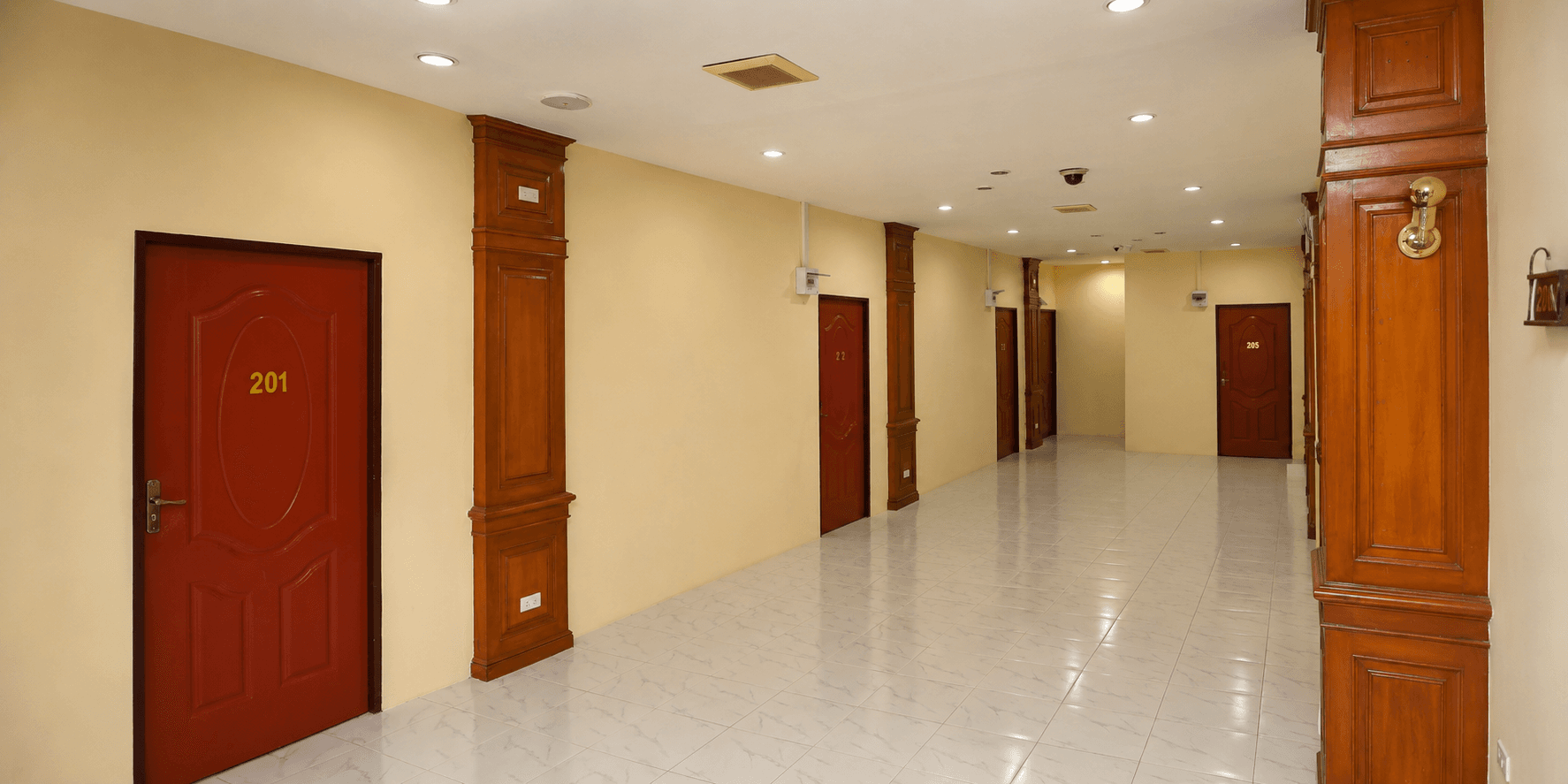 Crown Hotel corridor with red guest-room doors